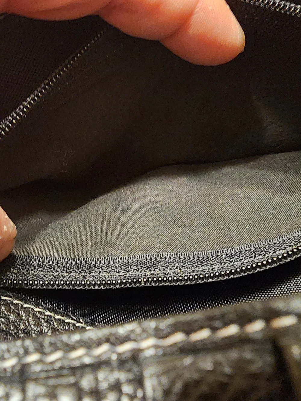 black Christian Dior pebbled leather trifold long wallet featuring gold-tone 